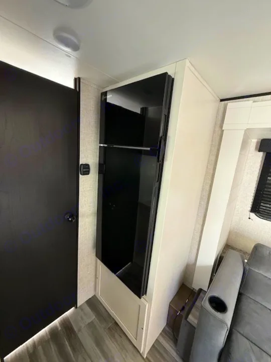 Discover comfort in your RV rental: a modern Everchill refrigerator and cozy seating define this inviting interior.. JAYCO Jay Flight 2025