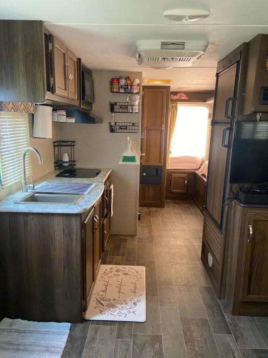 Spacious RV rental interior featuring a modern kitchen, cozy sleeping area, and ample storage for comfortable travel.. Keystone RV Bullet Crossfire 2018