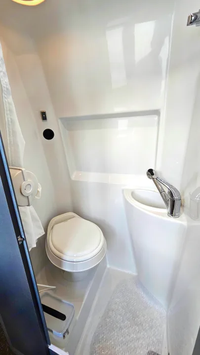 RV rental: compact wet bath featuring a toilet, integrated sink/shower, and non-slip mat. Optimal for small spaces.. Airstream Interstate 2024