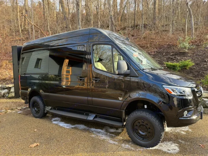 This sleek black Mercedes Sprinter van, converted to an RV with off-road tires, is perfect for an RV rental adventure.. Ultimate Toys Ultimate Cruiser 2024