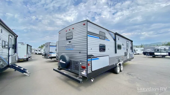 A vast lot of modern travel trailers and RVs, including a grey Catalina model, perfect for your next RV rental adventure.. Coachmen Catalina Legacy Edition 2022