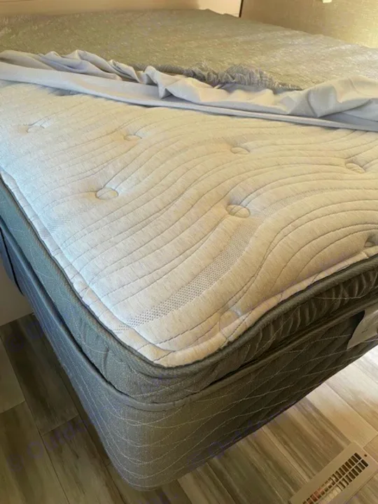 Comfortable, tufted mattress and dark grey base in this RV rental, ensuring cozy sleep for your travels.. Jayco Jay Flight SLX 2024