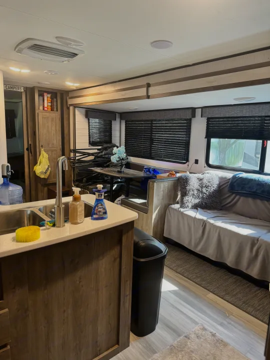 Step inside this inviting RV rental: kitchen, functional dinette, and relaxing lounge area. Your adventure awaits!. Heartland RVs Pioneer 2022