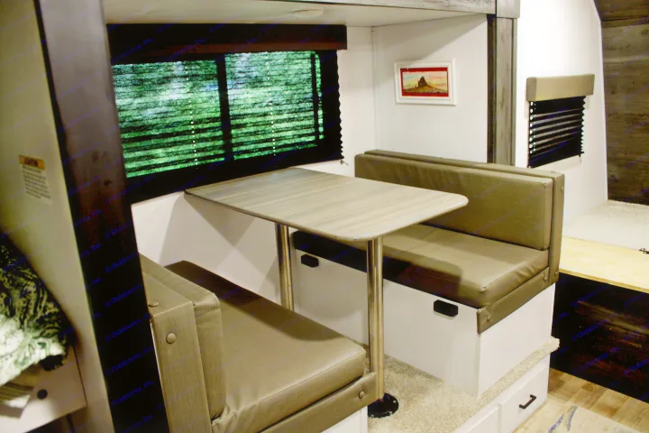RV rental interior: Comfortable dinette area with bench seating, ideal for dining or relaxing by the window.. Keystone RV Hideout 2022