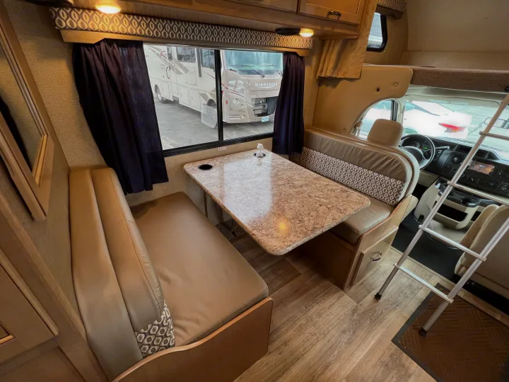 Inside this spacious rv rental, a cozy dinette with patterned cushions and a bunk bed offers comfort for your travels.. THOR MOTOR COACH Freedom Elite 2019