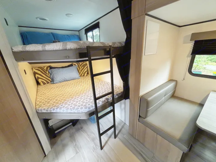 This RV rental offers a compact interior with comfy bunk beds and a dinette for dining/relaxation.. Keystone Coleman Light 2026