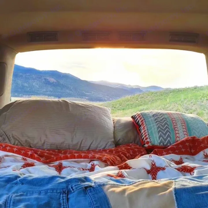 Scenic mountain view from a cozy vehicle bed, ideal for a glamping adventure or rv rental.. Chevrolet Astro 2003