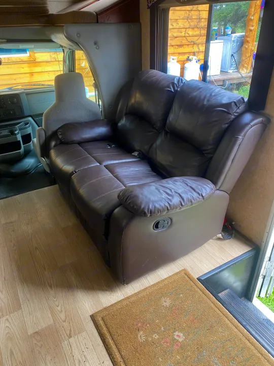 RV rental interior featuring a comfortable brown reclining sofa. Enjoy the cozy living space on your trip.. Forest River Sunseeker 2011