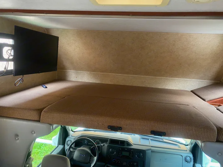 RV rental: Inside a cozy cab-over bunk with TV, perfect for sleeping or relaxing on your travels.. Forest River Sunseeker 2011