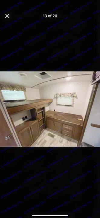 Spacious RV rental interior featuring bunk beds, a desk, and ample built-in storage, perfect for family adventures.. Keystone RV Cougar 2019
