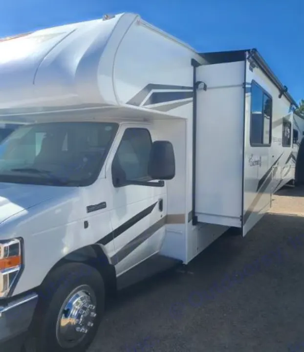 White Class C rv rental with an extended slide-out, parked on a sunny day. Ready for your adventure.. Forest River Coachmen Freelander 2025