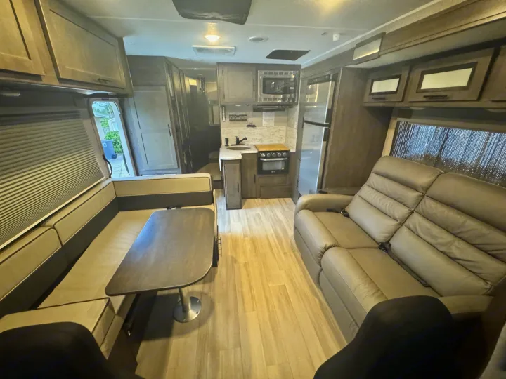 Spacious RV rental interior with modern kitchen, dinette, and comfortable seating, ideal for your next road trip.. Forest River Coachmen Leprechaun Premier 2022