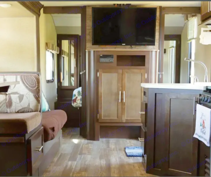 Explore this cozy RV rental interior featuring a dinette, entertainment center, and kitchen area.. Forest River Cherokee Grey Wolf 2016
