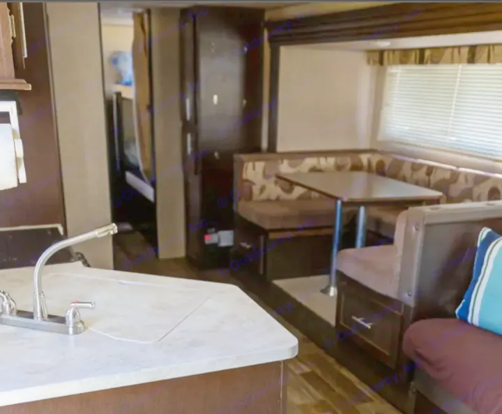 Explore this RV rental's spacious interior, featuring a full kitchen with a sink, comfortable dinette, and bunk beds.. Forest River Cherokee Grey Wolf 2016