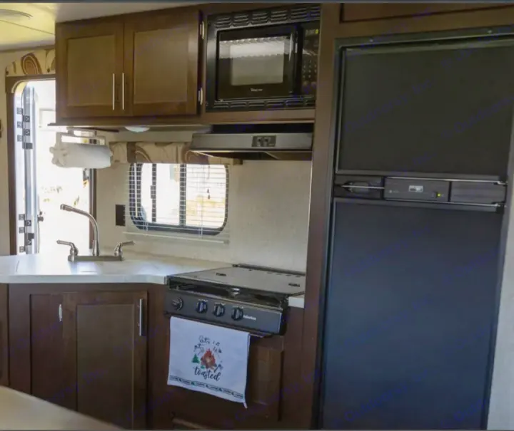 RV rental kitchen with sink, stove, microwave, and fridge. Perfect for your next adventure.. Forest River Cherokee Grey Wolf 2016