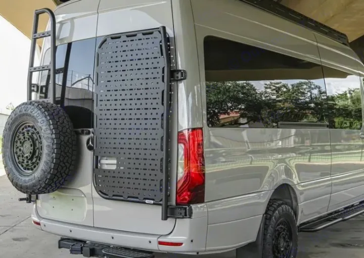 This custom adventure RV rental van sports a rear spare tire, ladder, and a versatile gear storage panel.. Mercedes Benz Sprinter 2500 2024