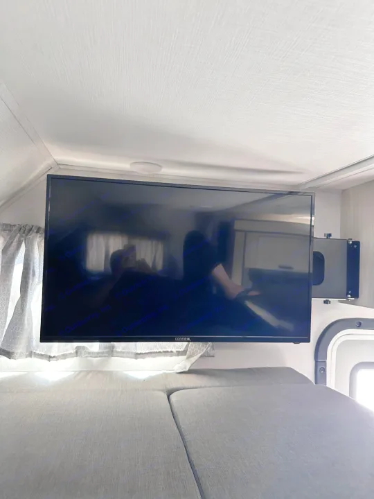 Enjoy an RV rental's entertainment with a mounted TV in the bunk bed area, complete with soft cushions.. Forest River Sunseeker Classic 2021