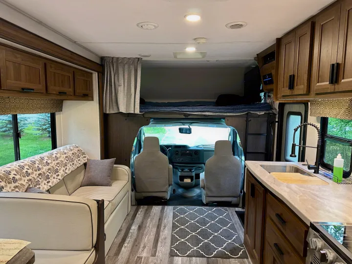 Inside this rv rental: a comfortable living space, functional kitchen, and overhead bunk above the driver's cab.. Forest River Sunseeker LE 2021