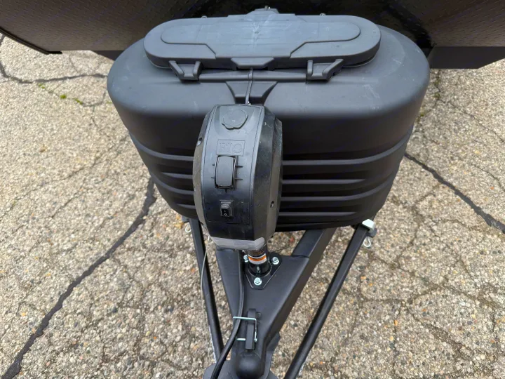 Close-up of an RV rental's black propane tank cover and electric tongue jack with UP/DOWN controls.. Jayco Jay Flight 2025
