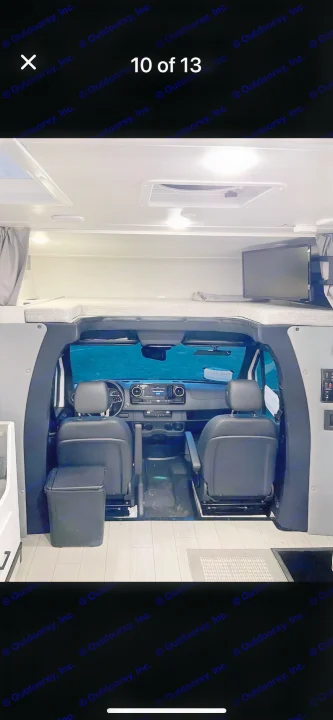 This RV rental interior features a spacious motorhome cockpit, overhead bunk bed, and mounted TV. Ready for adventure!. east to west entrada 2023