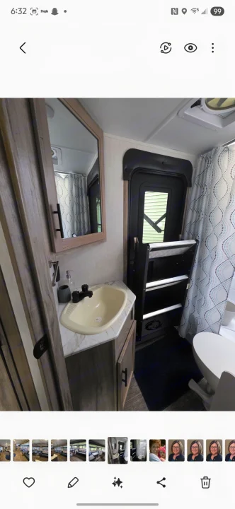 Compact RV rental bathroom: features sink, mirror, toilet, and shower. Ideal for mobile living.. Forest River Cherokee Alpha Wolf 2021