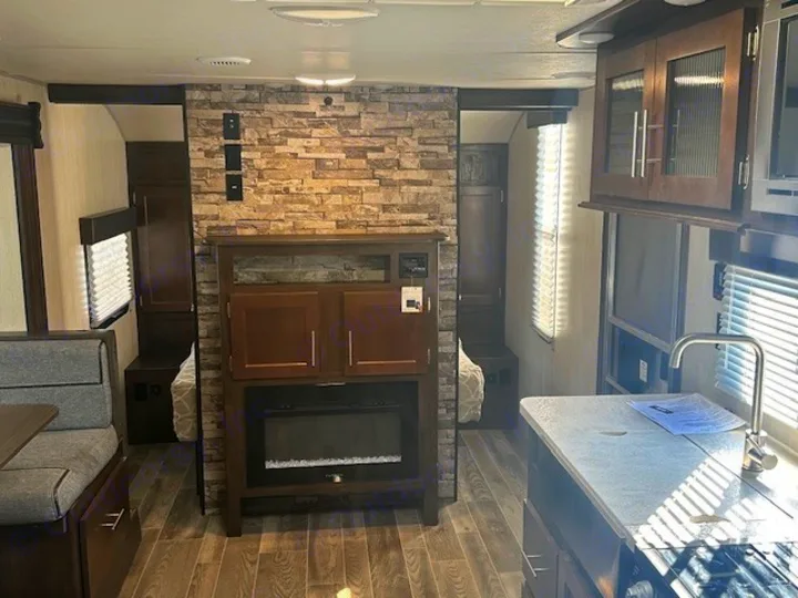 RV rental interior featuring a full kitchen, dinette, entertainment center, and private sleeping areas.. Forest River Cherokee Grey Wolf 2020