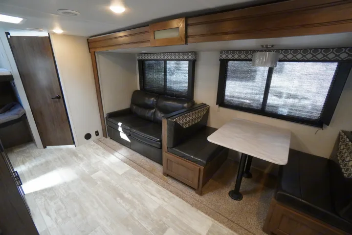 Explore this welcoming RV rental. It has a comfy sofa, dinette, and ample storage, with wood-look flooring and carpeted slide-out.. Forest River Tracer 2021