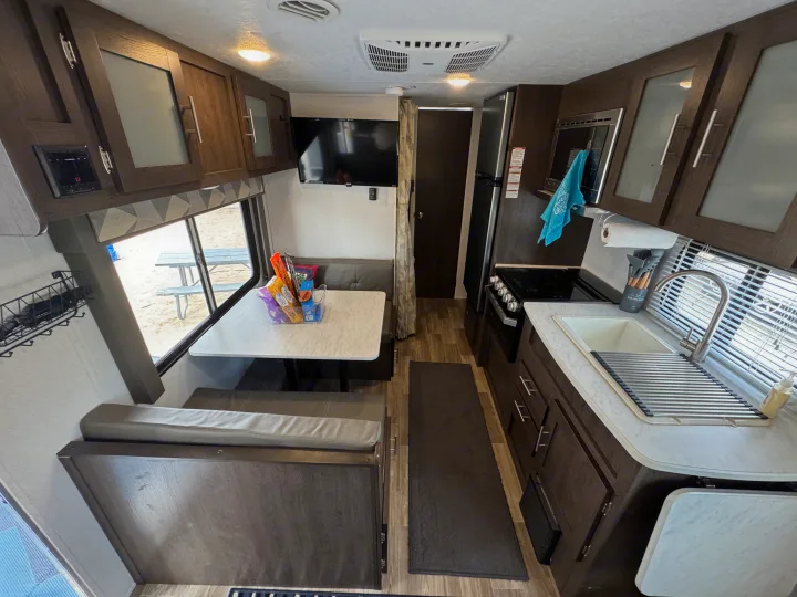 This RV rental offers a well-appointed interior with a bright kitchen, dining booth, and cozy living area for your travels.. Forest River Wildwood X-Lite 2019