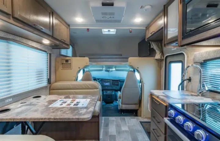 Explore this RV rental's spacious interior: full kitchen, dining, overhead bunk, & front cockpit. Perfect for your next adventure.. Thor Chateau 2022