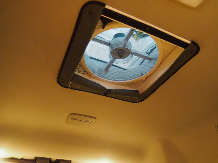 RV rental interior featuring a ceiling vent fan with a protective screen and visible controls.. Ford Transit 2019