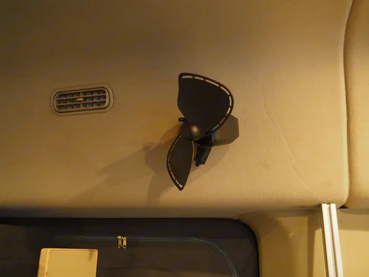 Stay cool in your rv rental: ceiling-mounted electric fan and air vent inside a camper van.. Ford Transit 2019