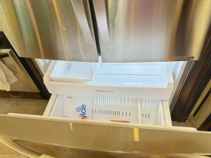 RV rental kitchen: Stainless steel refrigerator interior with bright pull-out drawers and ice bag.. 4x4fcmp23h6007284 Columbus 2017