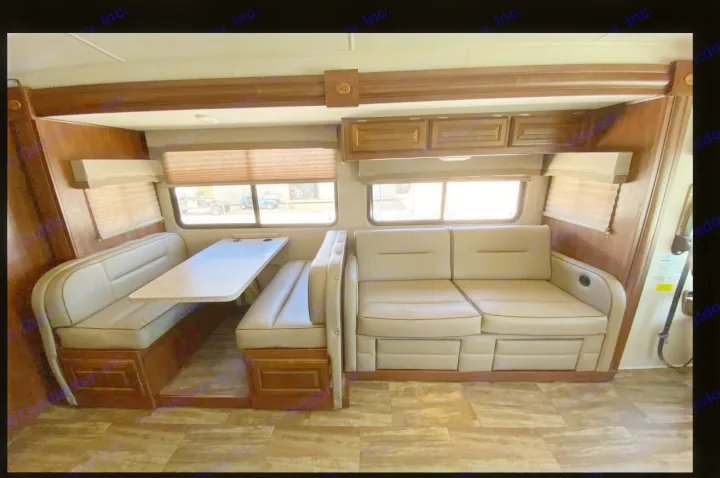 RV rental interior: A cozy dinette with bench seating and a table, plus a comfortable sofa.. Forest River Georgetown 2018