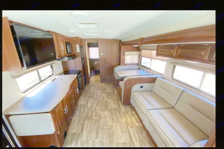 Spacious RV rental interior with kitchen, dinette, sofa, and TV, perfect for a comfortable road trip.. Forest River Georgetown 2018