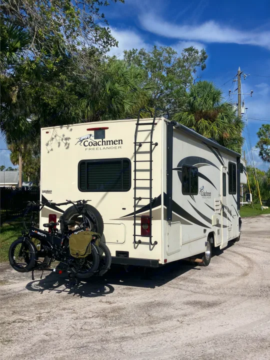 An RV rental, a Coachmen Freelander, with bikes on the back, parked outdoors. Perfect for travel adventures.. Forest River Coachmen Freelander 2017