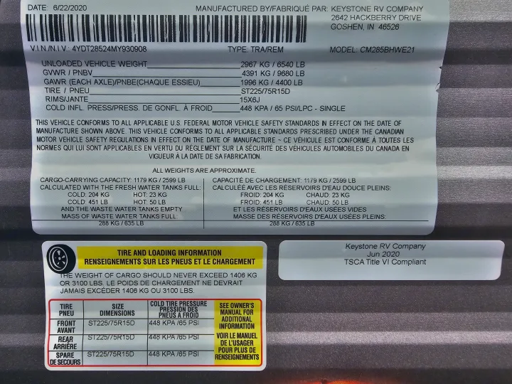 RV rental: Vehicle label showing detailed specs, weights, and tire information for a Keystone RV, model CM285BHWE21.. Dutchmen Coleman Lantern 2021