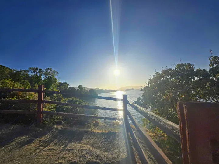 Scenic waterfront view from an ideal RV rental spot, sun glinting on water & trees. Perfect for your next outdoor adventure!. Entegra Launch Sprinter High Roof AWD 4x4 Camper Van 2025