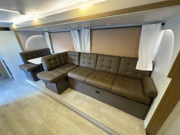 This RV rental interior features a modern kitchen, organized corner storage, and a light-toned wood-look floor.. Forest River Salem Cruise Lite 26ICE 2025