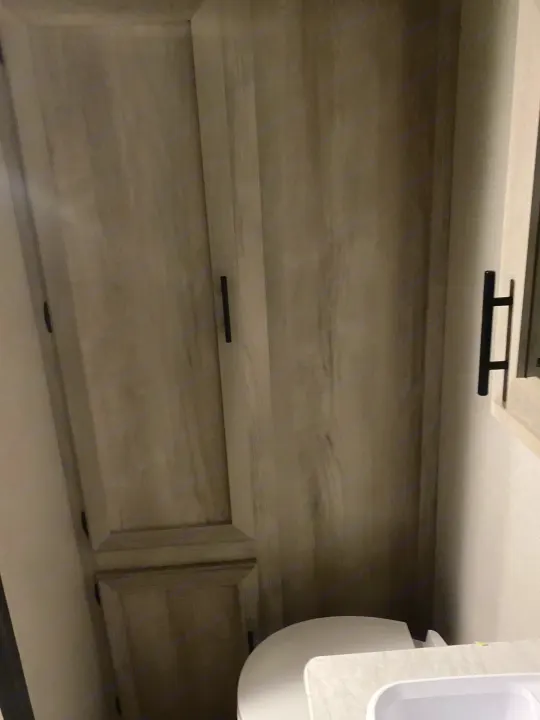 RV rental: Compact bathroom with light wood storage cabinet, toilet, and sink.. KZ Escape 2021