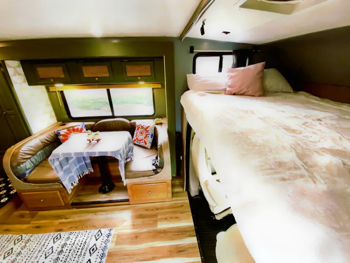 Cozy RV rental interior with a comfortable bed and spacious dinette, perfect for your next adventure.. Coachmen Leprechaun 2016