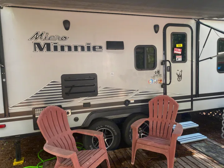 This Winnebago Micro Minnie travel trailer, featuring a 'SOLD' sign & chairs, embodies an ideal rv rental experience.. Winnebago Minnie Winnie 2020