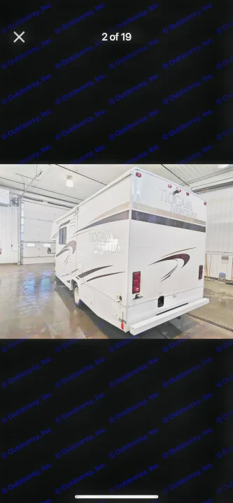 White Tioga Montara motorhome from the rear-side view, parked indoors. Perfect for your next rv rental adventure.. Tioga Montara 2012