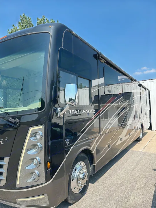 A sleek, dark Challenger RV rental, a spacious motorhome for memorable road trips.. Thor Challenger 2022
