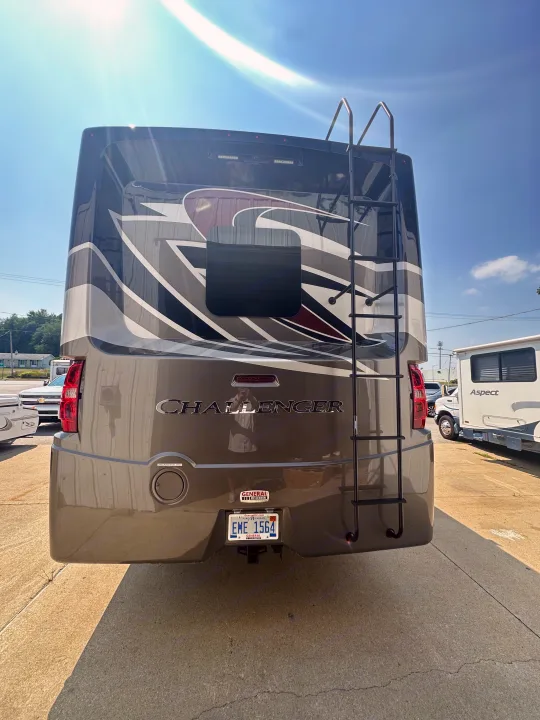 Rear view of a modern Challenger motorhome with a ladder and Michigan plate, ideal for an RV rental adventure.. Thor Challenger 2022