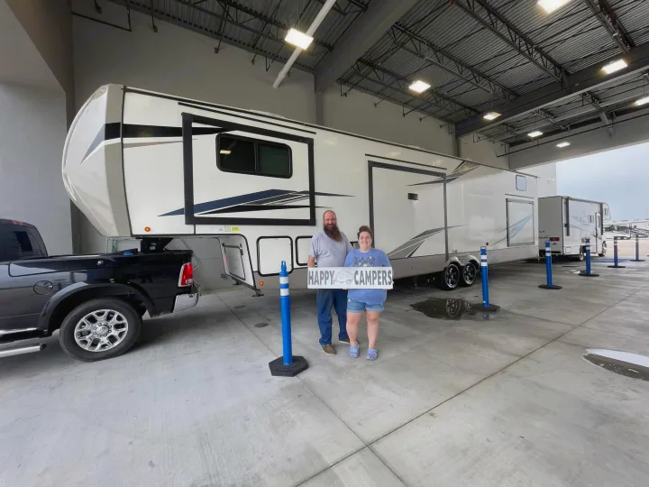 Happy campers celebrate their new, massive fifth-wheel RV. Perfect for travel, camping, or a luxurious RV rental.. Forest River Salem Hemisphere 2022
