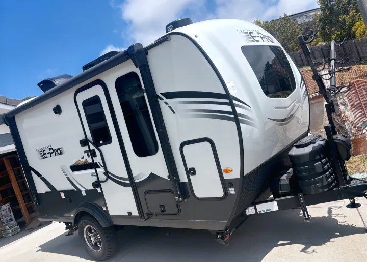 Compact white Flagstaff E-Pro travel trailer, perfect for an RV rental, solar-ready with a front bike rack.. Forest River Flagstaff E-Pro 2024