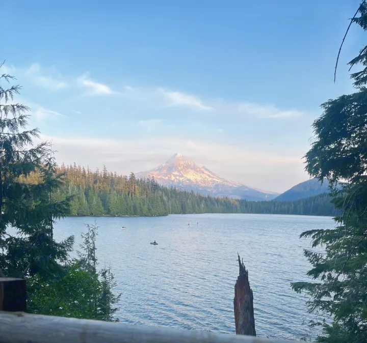 Stunning Mount Hood view over Trillium Lake with kayakers. Perfect serene backdrop for an RV rental escape.. Keystone RV Springdale 2022