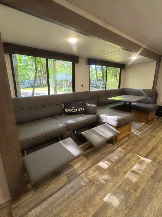 Spacious and comfortable RV interior with recliners and a dinette, perfect for your next rv rental adventure with a scenic view.. Forest River Cherokee Grey Wolf 2024