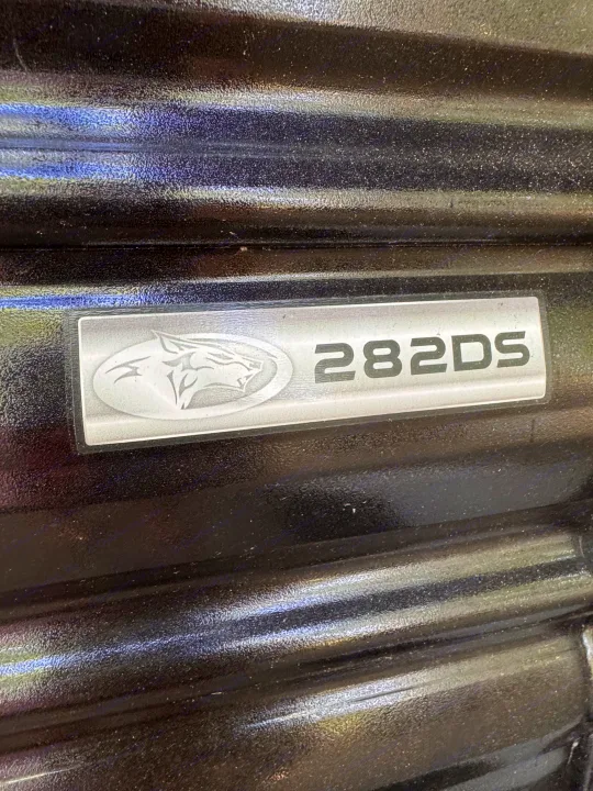 RV rental: Close-up of a travel trailer's 282DS model emblem on a textured surface, featuring a cougar logo.. Forest River Cherokee Grey Wolf 2024