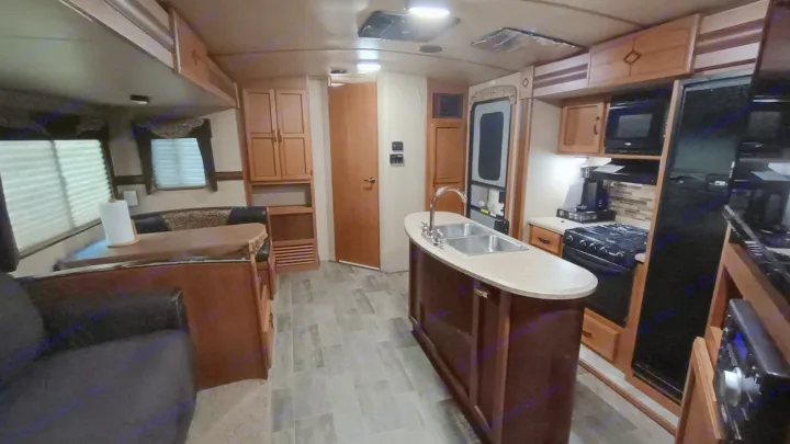 Explore this RV rental's spacious interior: full kitchen with stove, fridge, and island sink, plus a cozy dinette.. Crossroads RV Sunset Trail Super Lite 2017